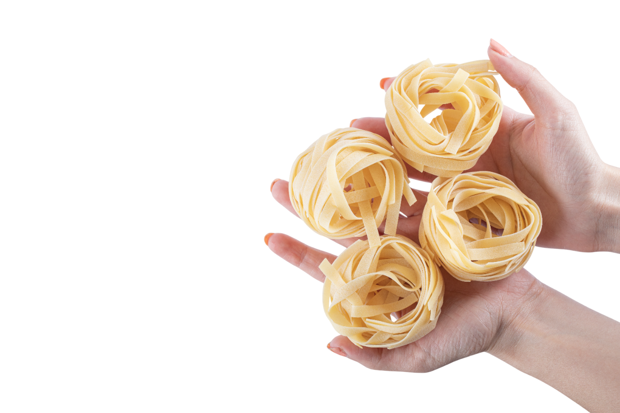 Female hands holding tagliatelle nests white Photoroom